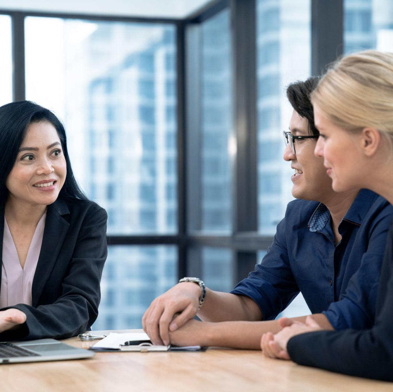 A couple discusses personal loans and credit with a credit union representative.